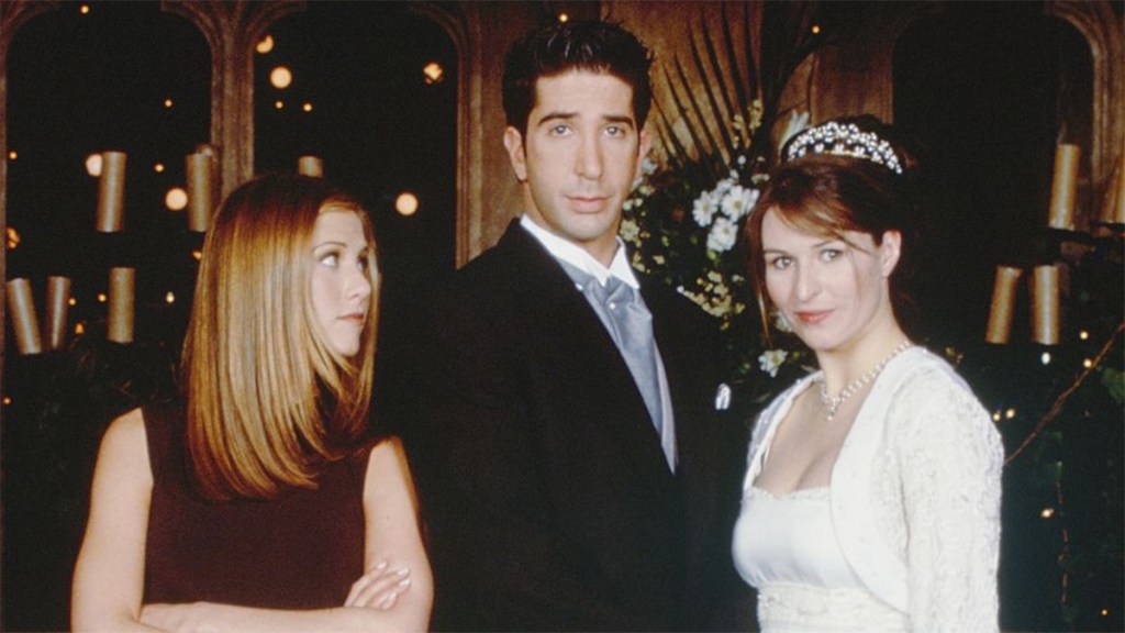 Jennifer Aniston as Rachel, David Schwimmer as Ross, and Helen Baxendale as Emily in a promotional still for Friends (Credit - NBC)
