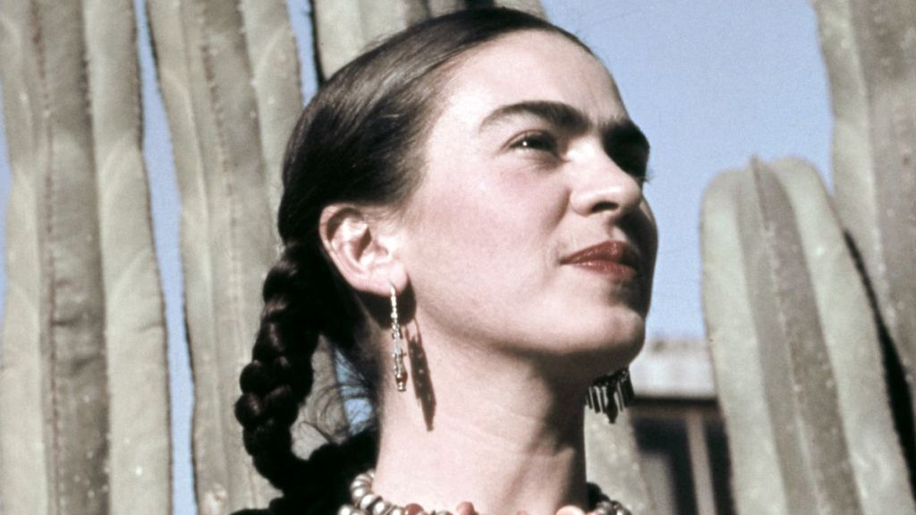 Artist Frida Kahlo poses for a portrait at the home and studio she shares with her husband, Diego Rivera