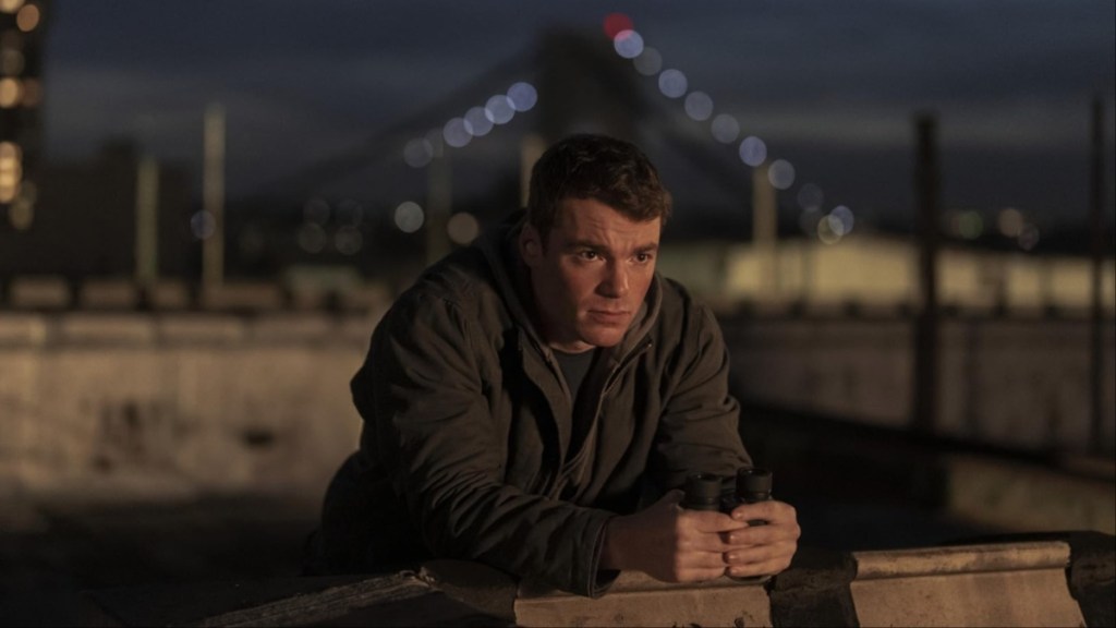 A man leans against the wall in The Night Agent.
