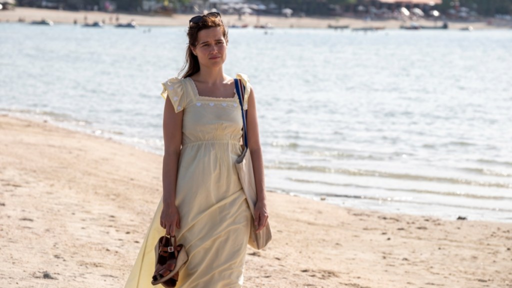 A woman walks down the beach.