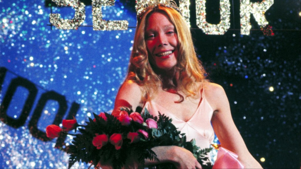 A girl holds up flowers.