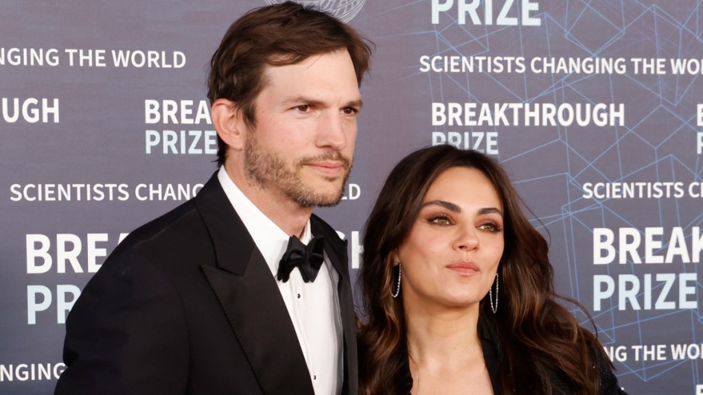 Ashton Kutcher & Mila Kunis Share PDA Moment at Backstreet Boys Concert