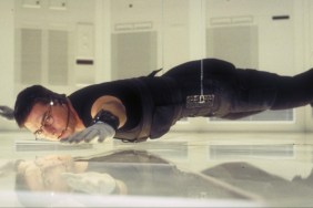 Tom Cruise hangs over the ground.