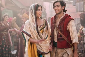 Naomi Scott stands next to Aladdin.