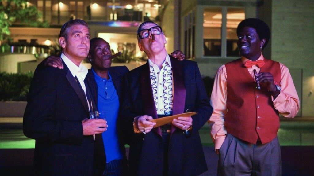 A group of men stand next to each other nad look up.