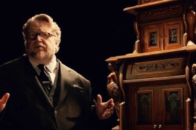 Guillermo del Toro stands in front of a clock.