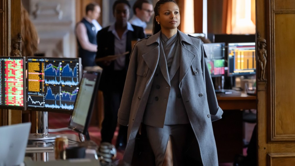 A woman walks in a coat in HBO's Industry.