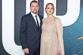 Leonardo DiCaprio stands next to Jennifer Lawrence.