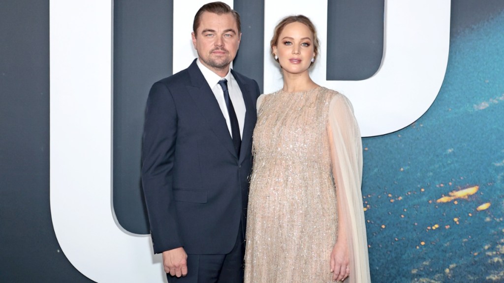 Leonardo DiCaprio stands next to Jennifer Lawrence.