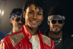 A man playing Michael Jackson smiles.