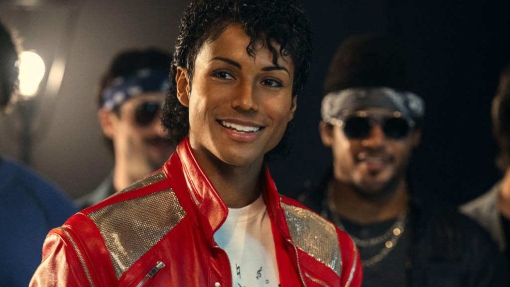 A man playing Michael Jackson smiles.