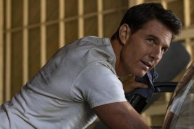 Tom Cruise leans up against a bike in Top Gun: Maverick.