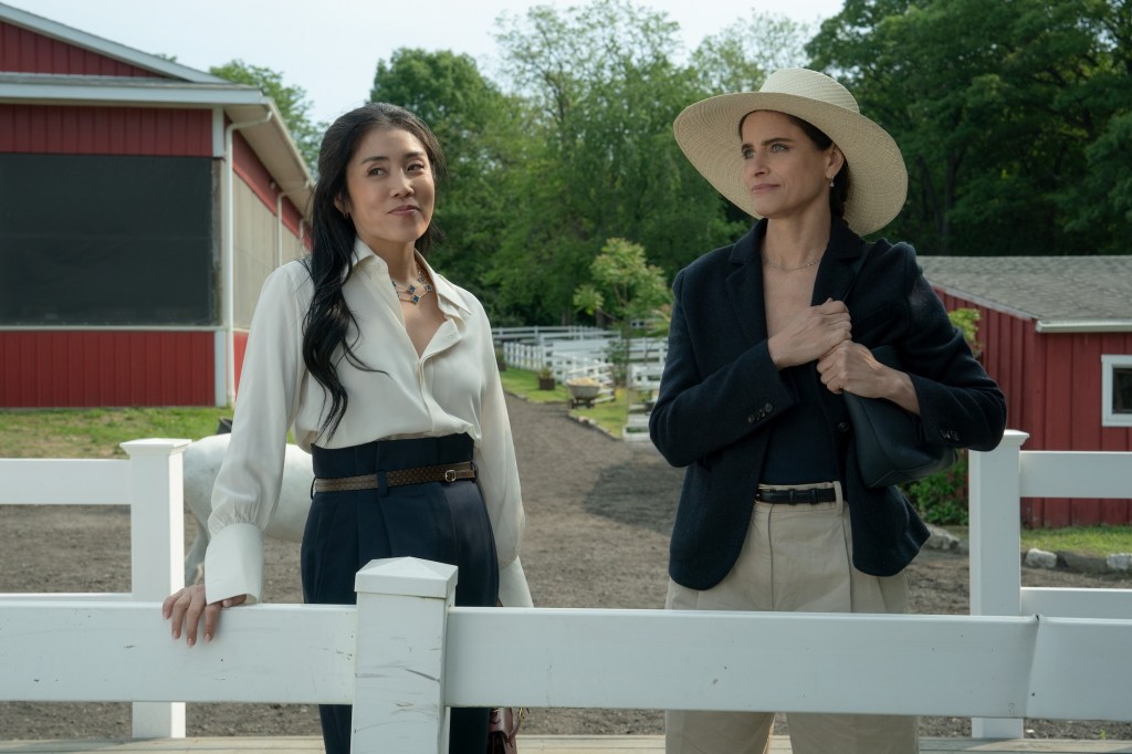 Two women stand over a fence in Your Friends & Neighbors Season 2.