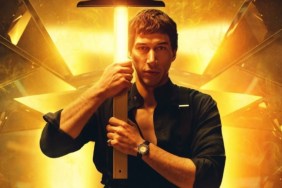 Adam Driver holds a cross in Megalopolis.