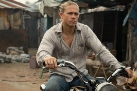 Charlie Hunnam sits on a motorcycle in Shantaram.