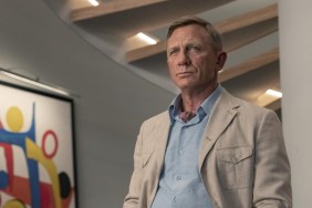Daniel Craig stands against a wall in Glass Onion.
