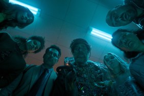 Sam Rockwell and a crew of people stand in a circle in Good Luck, Have Fun, Don't Die.