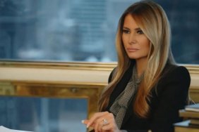 Melania Trump sits at a table in documentary.