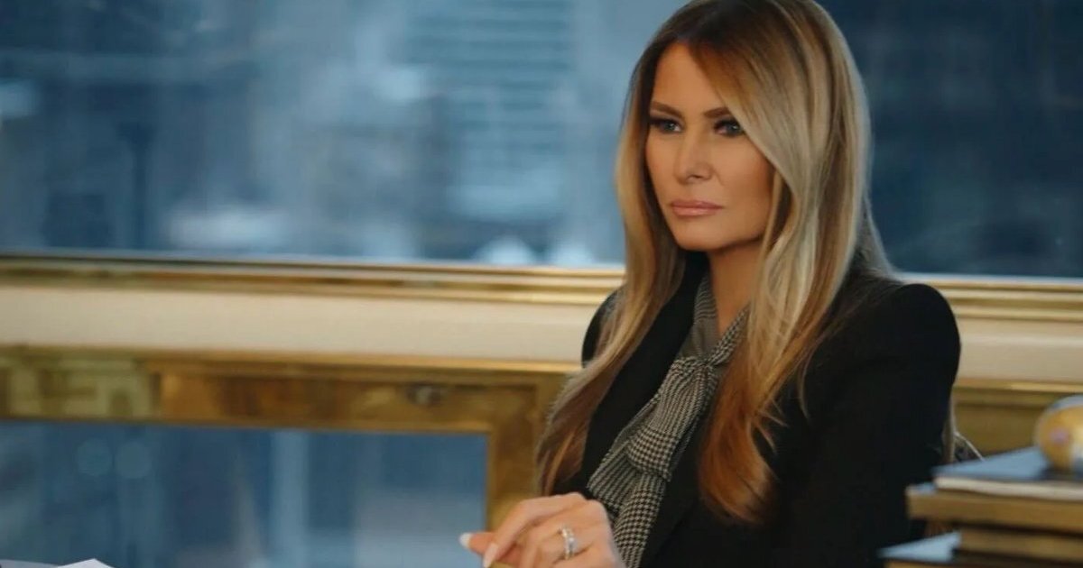 Melania Trump sits at a table in documentary.