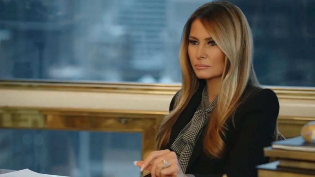 Melania Trump sits at a table in documentary.