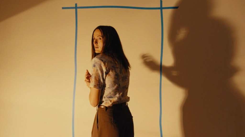 Renate Reinsve in front of a wall in Backrooms.