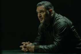 Tom Hardy sits at a table in MobLand.