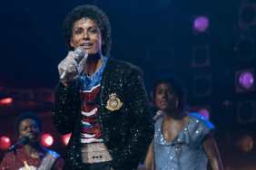 Jaafar Jackson holds up a mic in Michael.