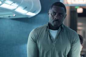 Idris Elba walks down an aisle in Hijack.