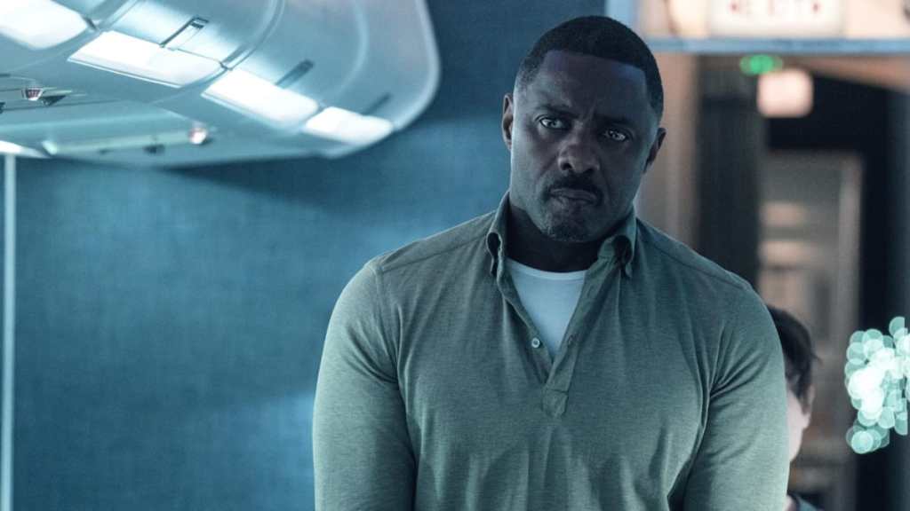 Idris Elba walks down an aisle in Hijack.