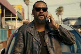 Jason Momoa holds a phone to his head in The Wrecking Crew.