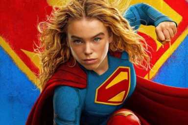 Milly Alcock holds up a fist as Supergirl.