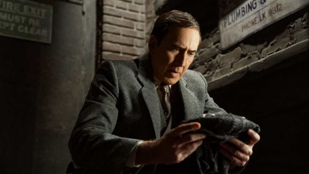 Nicolas Cage holds up a suit in Spider-Noir.