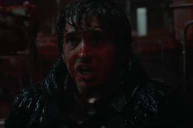 A bloody Austin Abrams screams in Resident Evil.