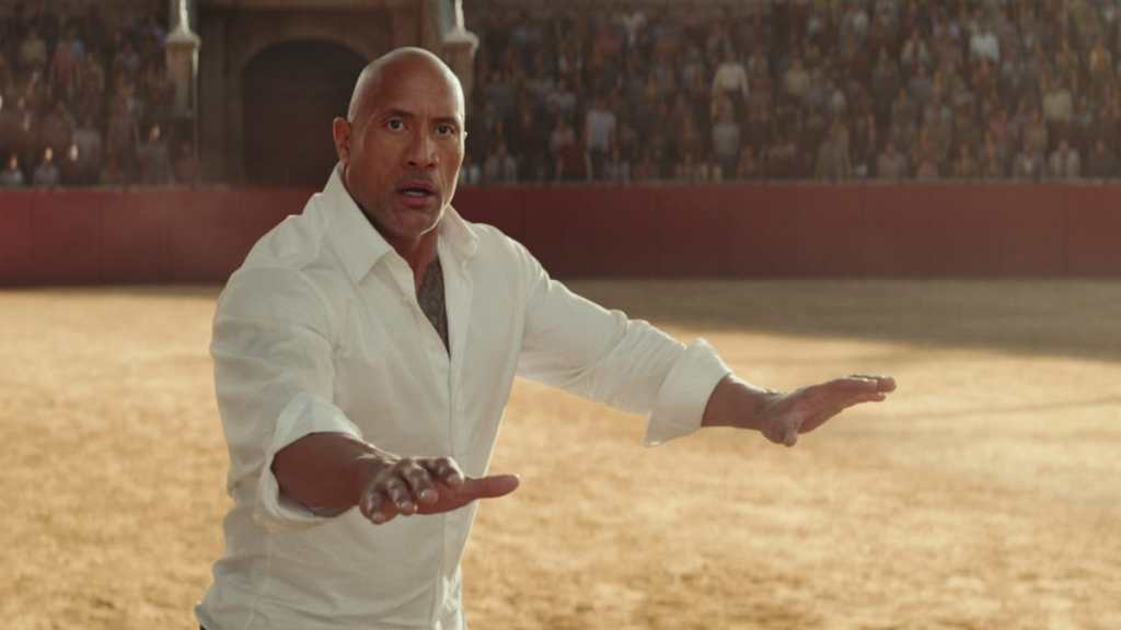 Dwayne Johnson puts his hands out in Red Notice.